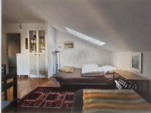 a living room with a bed and a rug at Ferienglück unterm Dach in Poreč