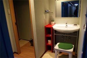 a bathroom with a sink and a mirror and a stool at Hotel Wako in Osaka +13 photos