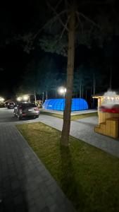 a car driving down a street at night at Ośrodek u Polaka-domek góralski in Radkowice