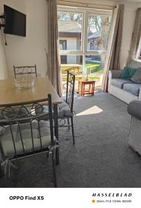a living room with a table and chairs and a couch at Tolroy manor holiday cottage in Saint Erth