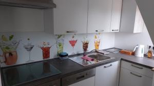 a kitchen with a sink and some vases on the wall at Schöne Ferienwohnung in Münster