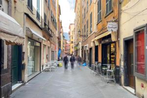 a couple of people walking down a street at Loft Mazzini Rapallo in Rapallo