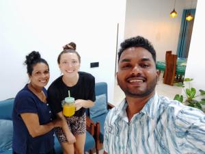 a group of three people standing around a man holding a drink at Hey Lala Talalla in Matara