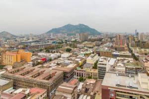 a city with buildings and a mountain in the background at Departamento santiago centro 2 personas in Santiago