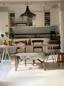 a kitchen with a table and chairs in a room at Cosy House in Otterlo