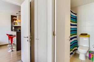 a bathroom with a toilet and a colorful striped towel at Departamento santiago centro 2 personas in Santiago