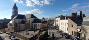 an old town with a church and a street with cars at MOINES - Centre historique de charme in Vannes