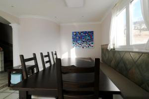 a dining room with a black table and chairs at Ferienwohnung Kraftquelle im Wohnpark SchwarzwaldBlick, Bernau in Bernau im Schwarzwald
