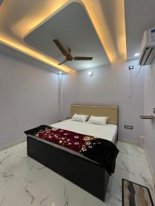a bedroom with a bed with a ceiling at Hotel S K in Naimishāranya