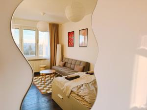 a living room with a bed and a couch at Byt v meste Piešťany in Piešťany
