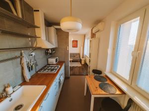 a kitchen with a sink and a counter top at Byt v meste Piešťany in Piešťany