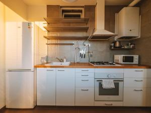 a kitchen with a white refrigerator and a sink at Byt v meste Piešťany in Piešťany +30 photos