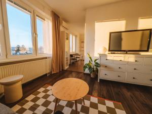 a living room with a television on a dresser at Byt v meste Piešťany in Piešťany
