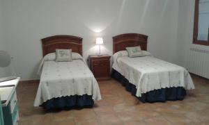 En eller flere senge i et værelse på Vut 47 62 La Ventanita de Rioseco