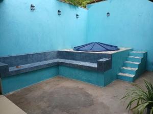 a blue wall with stairs and an umbrella on it at Casa Moriá in Lençóis