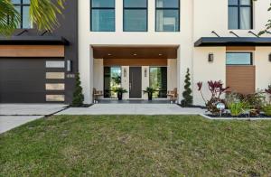 a house with a front door and a yard at Coastal Luxe, SaltPool Spa, 5miles to Siesta in Sarasota