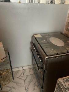 a stove top oven sitting in a kitchen at Residence Colette in Douala +7 photos
