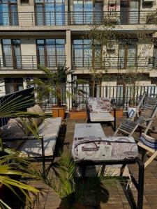 a patio with chairs and a table on a building at Villa with rooftop hot tub in Tbilisi City +35 photos