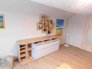 a room with a desk and shelves on the wall at Ferienwohnung Uschi 1 in Peiting