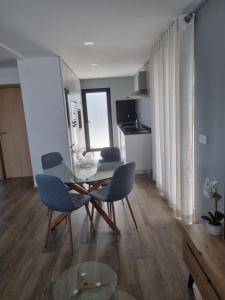 a living room with a table and chairs in a room at Felicidade in Mondim de Basto