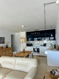 a living room with a white couch and a table at Carmen Apartamento Eleanora in Nerja