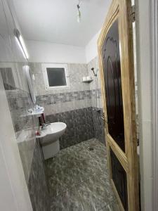 a small bathroom with a sink and a toilet at Diar Aquilaria Dar nouha in El Haouaria
