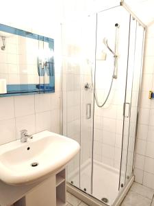 a bathroom with a sink and a shower at La Casa di Adele AFFITTACAMERE in Porto SantʼElpidio