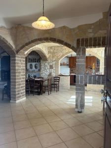 a kitchen and dining room with a stone wall at Green Residence Villa Assunta in Moscufo