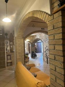 a living room with a brick wall and a couch at Green Residence Villa Assunta in Moscufo +57 photos