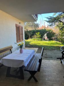 a table and a bench on a patio at Villa Maris Izola in Izola +55 photos