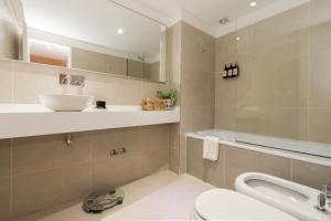 a bathroom with a sink and a toilet at Pacifico Departamentos in Ushuaia +90 photos