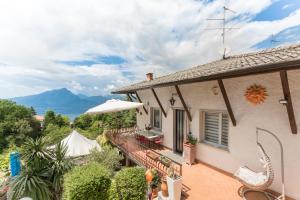 a house with a balcony with a view of the mountains at Casa HELI 1 in San Zeno di Montagna