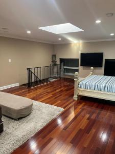 a living room with a bed and a flat screen tv at Large 2Level 3BR, 3BA Condo with free parking near Downtown Washington DC in Washington