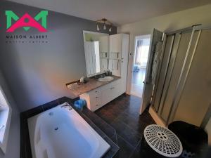 a bathroom with a tub and a sink at Maison Albert in Petite-Vallée +15 photos
