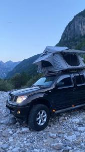 a black truck with a tent on top of it at ALB Car Camping in Grilë