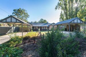 
a large building with a fence around it at Stoneleigh Cottage Bed and Breakfast in Angaston
