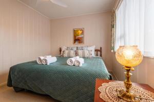 une chambre avec un lit avec des serviettes dessus dans l'établissement Central Hotspot, à Rotorua