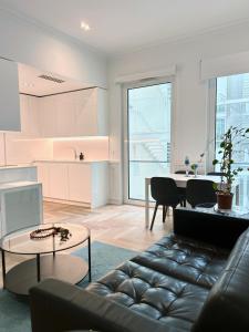 a living room with a couch and a table at Boulevard Lisbon Prime Suite in Lisbon