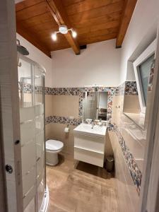 a bathroom with a sink and a toilet at La Dimora del Viandante in San Giorgio +11 photos