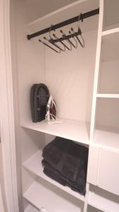 a walk in closet with white shelves and towels at Spacious Bright 9ft Ceiling with Private Entrance in Milton