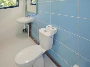 a bathroom with a white toilet and a sink at Holiday Home in Sulomino with Private Beach in Dargobądz