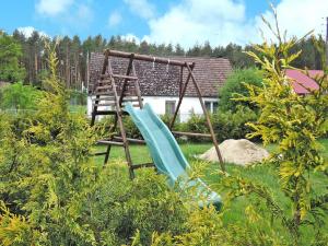 a playground with a blue slide in a yard at Family House near Baltic Sea and Szczecin Lagoon in Dargobądz