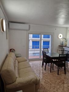 a living room with a couch and a table at SunandSea in L'Estartit