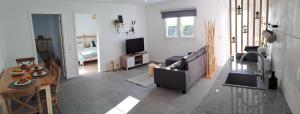 a living room with a couch and a table at PenaWoods in A dos Cunhados