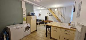 a kitchen and living room with a washer and dryer at Entre Terres et Mer in Samer