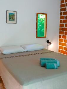 a bed with two pillows on top of it at Estalagem Santo André in Santo André