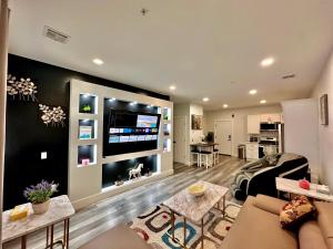 a living room with a large flat screen tv at The Stylish Suite - 1BR with Free Parking in Paterson