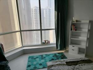 a room with a large window with a view of a city at Majaz3 in Sharjah +5 photos
