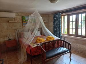 a bedroom with a bed with a mosquito net at Finca La Vida Apartment Boungavilla in Llucmajor