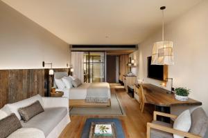 a bedroom with a bed and a living room at 1 Hotel Melbourne in Melbourne